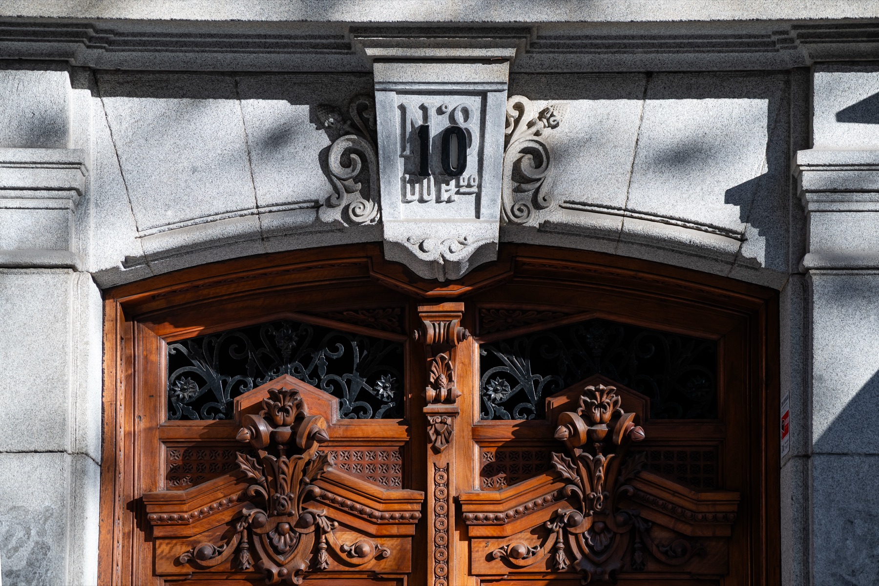 Ornate carved wooden door of a historic building in central Madrid