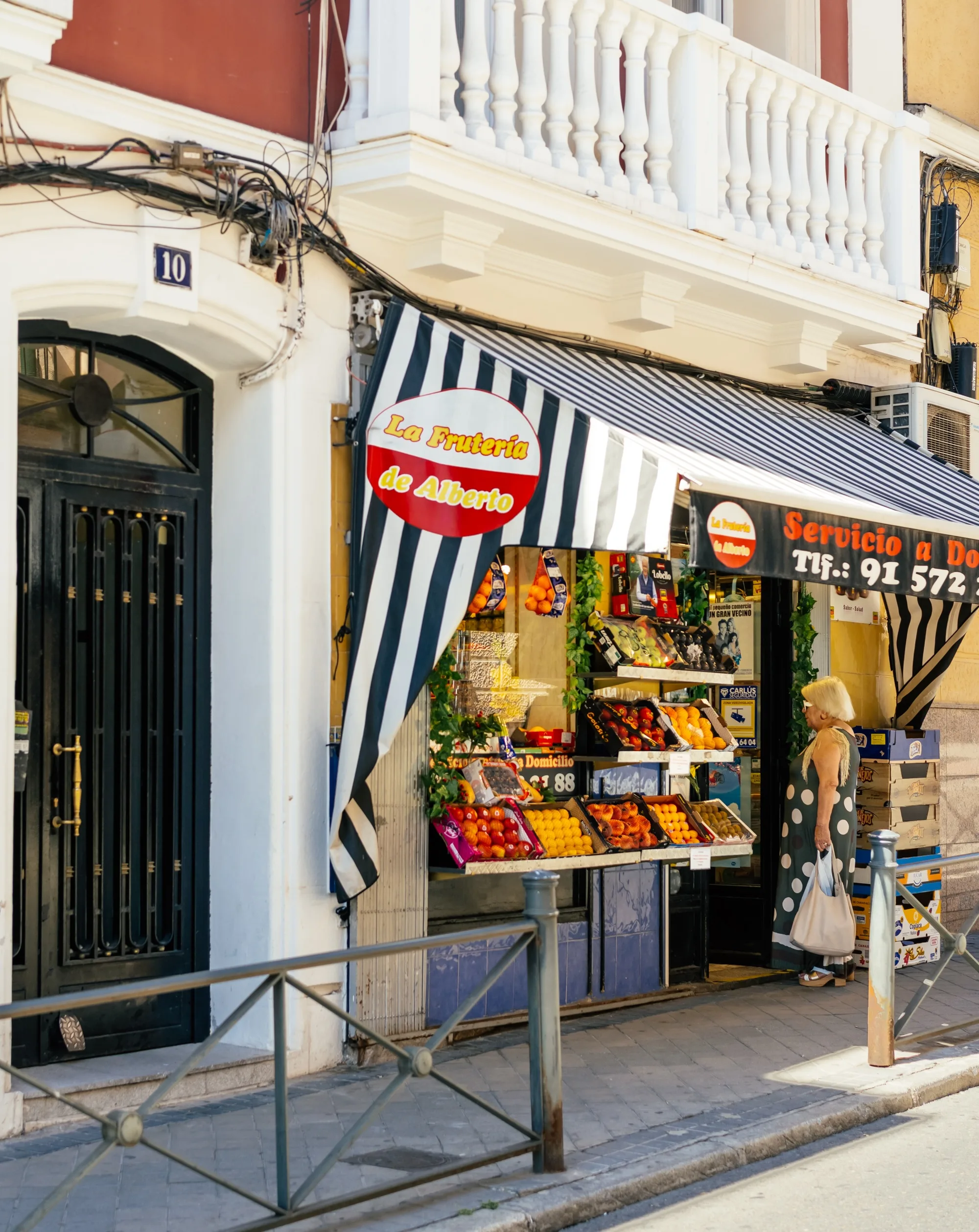 A large floral street-art mural covering a residential façade in Cuatro Caminos